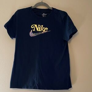 Nike Women's Black Tee with Gold Logo and Multicolor Swoosh Pattern